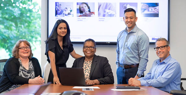 A photo of a group of team members in a office