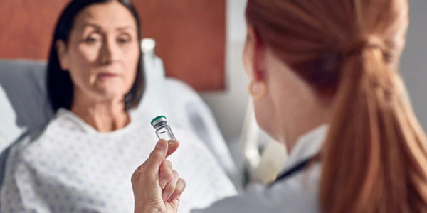 Doctor showing medication to patient