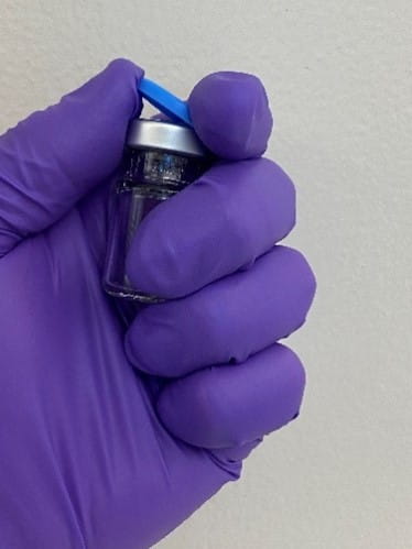 One-handed vial cap flip-off.