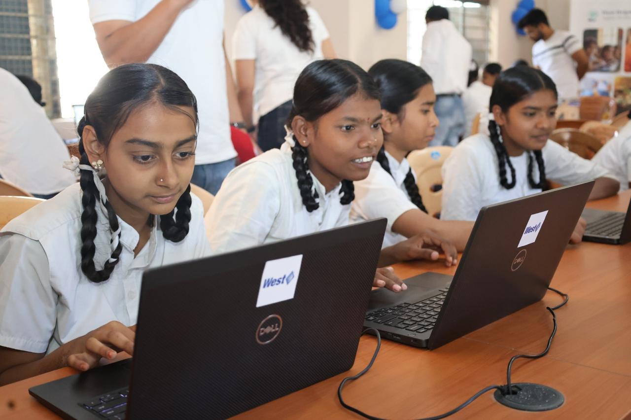 Students using donated laptops during a digital learning session.