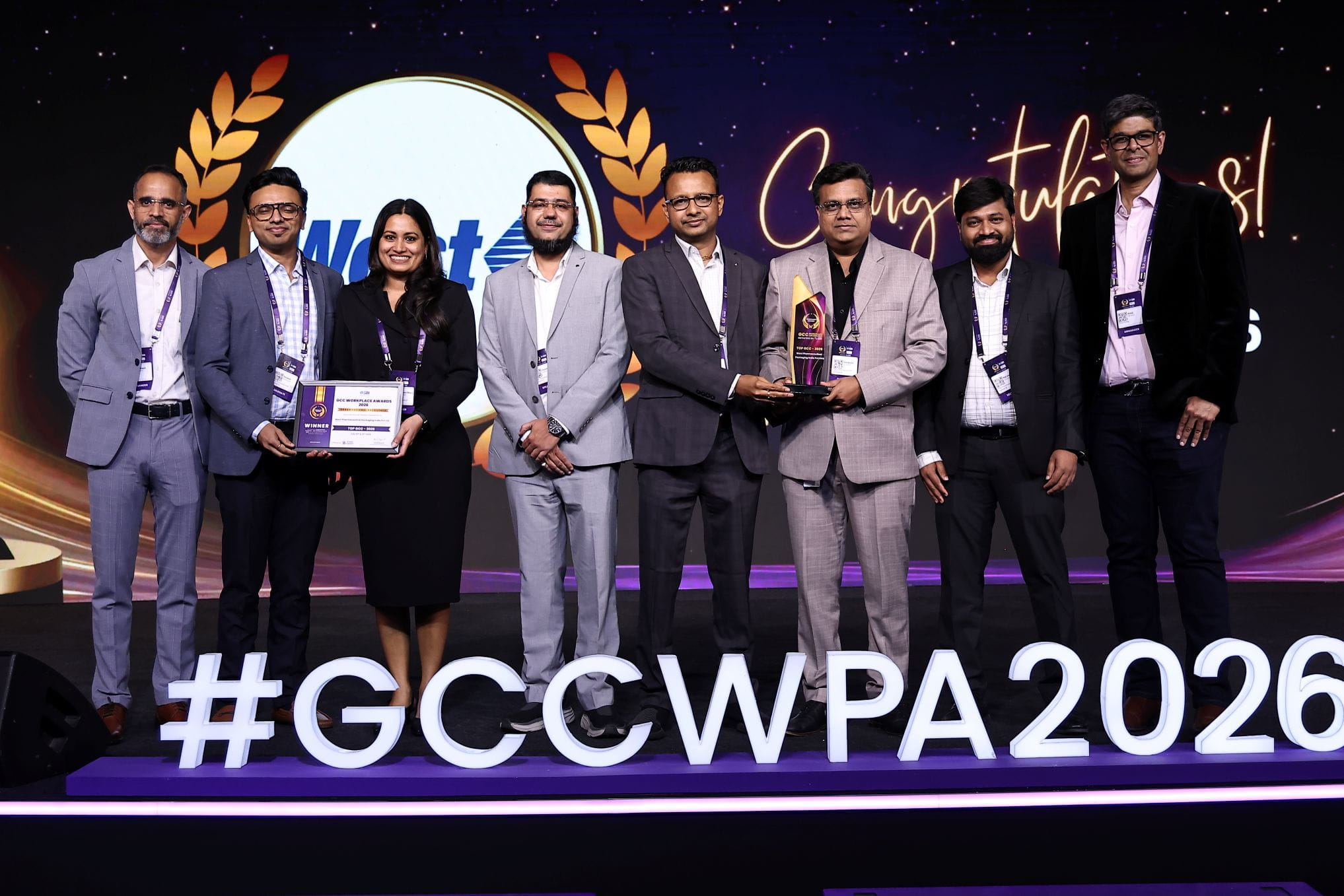 West team receiving the GCC Workplace Awards 2026 recognition on stage with award trophy and certificate.