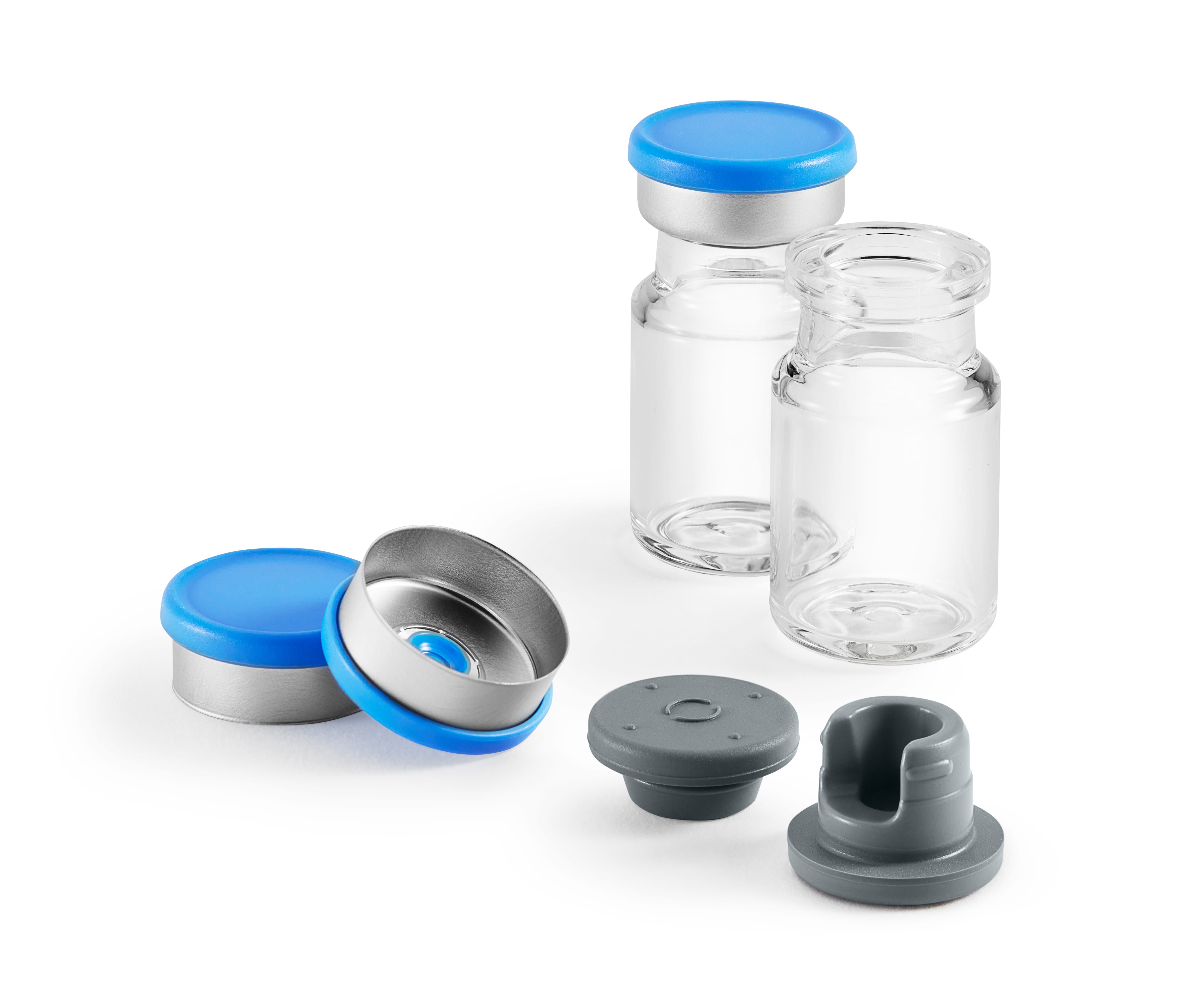 Glass vials with aluminum seals, blue flip-off caps, and gray rubber stoppers used for injectable drug packaging.