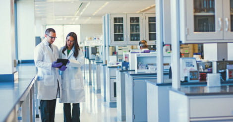 two Analytical Lab employees in laboratory