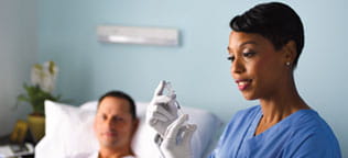 Nurse filling up syringe with vial 