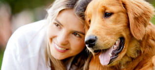 A girl smiling with her dog