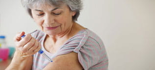 A lady with Diabetes giving herself an injection