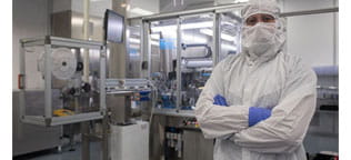 Scientist in Lab looking at camera