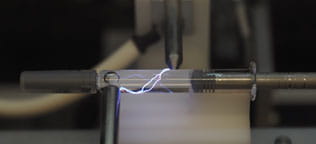 Glass syringe undergoing high voltage leak detection