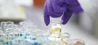 Analytical Scientist placing a beaker down