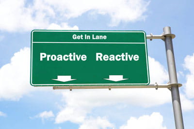 Green sign that says get in lane proactive reactive
