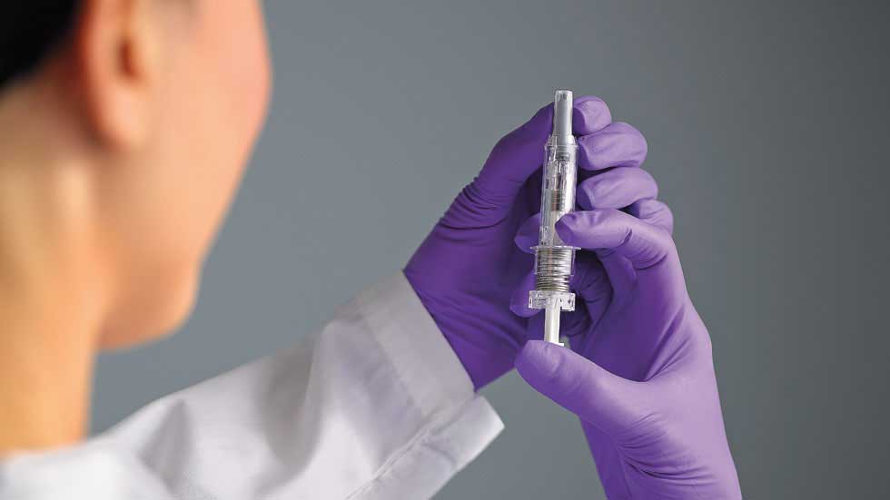 A doctor using a West safety syringe