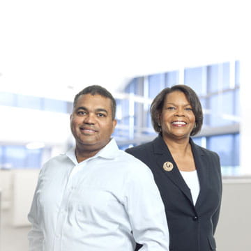 Two West regulatory employees in an office setting